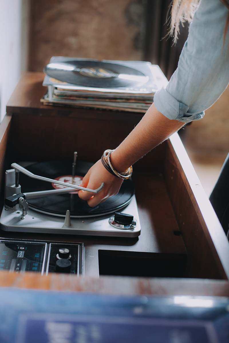 austin person holding gray and black vinyl record player united states
